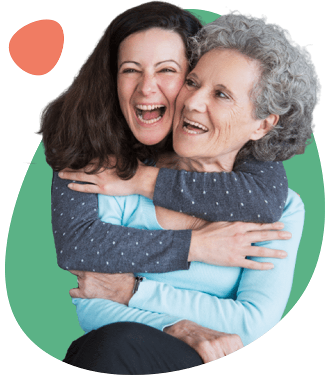 A daughter and her mother embracing and laughing